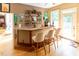 Charming home bar with granite countertop, stocked shelves, and seating for three at 5240 Indigo Moon Way, Raleigh, NC 27613