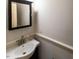 Small bathroom with pedestal sink and framed mirror at 5240 Indigo Moon Way, Raleigh, NC 27613