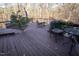 Elevated outdoor dining area featuring a wooden deck and lush greenery at 5240 Indigo Moon Way, Raleigh, NC 27613