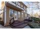 Exterior view of the home, featuring a deck, multiple windows, and a stone pathway at 5240 Indigo Moon Way, Raleigh, NC 27613