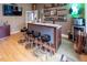 Home bar with granite countertop and shelving; four barstools at 5240 Indigo Moon Way, Raleigh, NC 27613