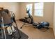 Home gym with various exercise equipment including an elliptical and weight machine at 5240 Indigo Moon Way, Raleigh, NC 27613