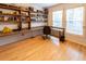 Home office with built-in shelving, hardwood floors, and large windows at 5240 Indigo Moon Way, Raleigh, NC 27613