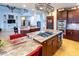 Spacious open kitchen features a granite island, cooktop, stainless steel ovens, and seating for bar stools at 5240 Indigo Moon Way, Raleigh, NC 27613