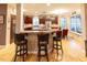 Kitchen features breakfast bar with granite countertops and hardwood floors at 5240 Indigo Moon Way, Raleigh, NC 27613