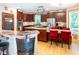 Spacious eat-in kitchen with large island featuring a cooktop, granite countertops, stainless oven and barstool seating at 5240 Indigo Moon Way, Raleigh, NC 27613