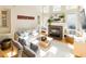 Cozy living room with a fireplace, large windows, comfortable seating, and hardwood floors at 5240 Indigo Moon Way, Raleigh, NC 27613