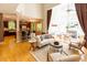 Spacious living room and kitchen area with hardwood floors, a fireplace, and comfortable seating at 5240 Indigo Moon Way, Raleigh, NC 27613