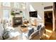 Inviting living room features a fireplace, hardwood floors, large windows, and comfortable seating at 5240 Indigo Moon Way, Raleigh, NC 27613