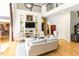 Open-concept living room with hardwood floors, built-in shelving, and a view of the upper level at 5240 Indigo Moon Way, Raleigh, NC 27613