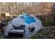 A stunning kidney-shaped pool surrounded by a stone patio and lush landscaping, perfect for outdoor relaxation at 5240 Indigo Moon Way, Raleigh, NC 27613