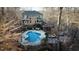Aerial shot of a beautiful backyard with a pool, multiple seating areas, and lush trees at 5240 Indigo Moon Way, Raleigh, NC 27613
