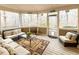 Relaxing screened porch with wooded views, wicker furniture, and a coffee table at 5240 Indigo Moon Way, Raleigh, NC 27613