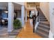 Elegant staircase with hardwood flooring and simple black railing at 5240 Indigo Moon Way, Raleigh, NC 27613