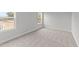 Bright bedroom with carpeted floors and two windows at 529 Ravensworth Dr, Garner, NC 27529