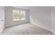 Bright bedroom featuring a large window and carpet flooring at 529 Ravensworth Dr, Garner, NC 27529