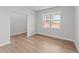 Spacious bedroom with light walls, wood-look floors, and a window at 529 Ravensworth Dr, Garner, NC 27529
