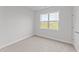 Simple bedroom with light walls, carpeted floors, and a window at 529 Ravensworth Dr, Garner, NC 27529