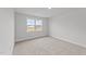 Bright bedroom with carpeted floors and large window at 529 Ravensworth Dr, Garner, NC 27529