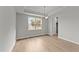 Dining room with light walls, wood-look floors, and a chandelier at 529 Ravensworth Dr, Garner, NC 27529