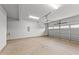 Spacious garage with overhead door and concrete floor at 529 Ravensworth Dr, Garner, NC 27529