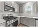 Modern kitchen with stainless steel appliances and white cabinets at 529 Ravensworth Dr, Garner, NC 27529