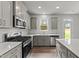 Modern kitchen with stainless steel appliances and white cabinets at 529 Ravensworth Dr, Garner, NC 27529
