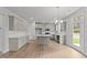 Modern kitchen with island, stainless steel appliances, and white cabinets at 529 Ravensworth Dr, Garner, NC 27529