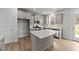 Modern kitchen with island, stainless steel appliances, and white cabinets at 529 Ravensworth Dr, Garner, NC 27529