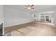 Open living room with hardwood floors and fireplace, open to kitchen at 529 Ravensworth Dr, Garner, NC 27529