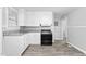 Simple kitchen featuring white cabinets, granite countertops, and wood-look floors at 601 Second Ave, Burlington, NC 27215