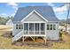 Gray house exterior with screened porch and landscaped yard at 824 Crimson Ridge Trl, Fuquay Varina, NC 27526