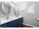 Bathroom boasts double vanity with blue cabinets and quartz countertop at 902 Apple St, Gibsonville, NC 27249