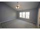 Spacious bedroom with ceiling fan and large windows at 1013 Red Hat Ln, Durham, NC 27713