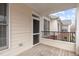 View from wood balcony with screen door and view of brick townhouse at 105 Fountain Ridge Pl, Holly Springs, NC 27540