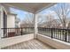 A wood balcony with black metal railing overlooks a neighborhood street at 105 Fountain Ridge Pl, Holly Springs, NC 27540