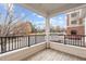 A wood balcony with black metal railing provides an outdoor living space at 105 Fountain Ridge Pl, Holly Springs, NC 27540
