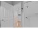 Modern bathroom featuring white tiling, shower with fixtures, and open doorway to living area at 105 Fountain Ridge Pl, Holly Springs, NC 27540