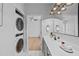 Modern bathroom featuring marble floors, a washer-dryer, and an ensuite bathroom with hardwood floors at 105 Fountain Ridge Pl, Holly Springs, NC 27540