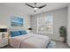 Stylishly furnished bedroom with a comfortable bed, modern art, and bright window views at 105 Fountain Ridge Pl, Holly Springs, NC 27540