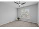 Bright bedroom with a large window providing natural light and a modern ceiling fan at 105 Fountain Ridge Pl, Holly Springs, NC 27540