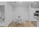 Cozy dining area featuring hardwood floors, white walls, and adjacent to kitchen area at 105 Fountain Ridge Pl, Holly Springs, NC 27540