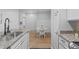 Modern kitchen features a dining set, stainless steel appliances, granite countertops and stylish cabinets at 105 Fountain Ridge Pl, Holly Springs, NC 27540
