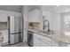 Modern kitchen with stainless steel appliances, granite countertops, and stylish cabinets at 105 Fountain Ridge Pl, Holly Springs, NC 27540