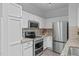 Modern kitchen features stainless steel appliances, granite countertops, tile backsplash, and stylish cabinets at 105 Fountain Ridge Pl, Holly Springs, NC 27540