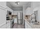 Modern kitchen features stainless steel appliances, granite countertops, tile backsplash, and stylish cabinets at 105 Fountain Ridge Pl, Holly Springs, NC 27540