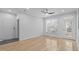 Bright living room featuring hardwood floors, a ceiling fan, and a glass door leading to a balcony at 105 Fountain Ridge Pl, Holly Springs, NC 27540