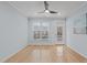 Open living room showcasing hardwood floors, a ceiling fan, a window with blinds, and neutral paint at 105 Fountain Ridge Pl, Holly Springs, NC 27540