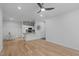 Spacious living room with hardwood floors, ceiling fan, and view to dining and kitchen area at 105 Fountain Ridge Pl, Holly Springs, NC 27540
