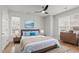 Serene main bedroom with light wood floors, a ceiling fan, and panel molding accents walls at 105 Fountain Ridge Pl, Holly Springs, NC 27540